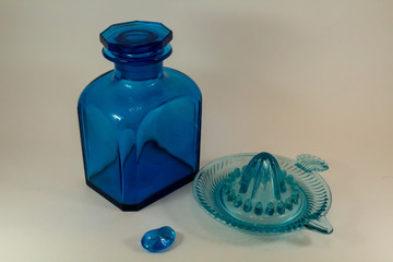 vintage blue glass bottle and vintage citrus juicer