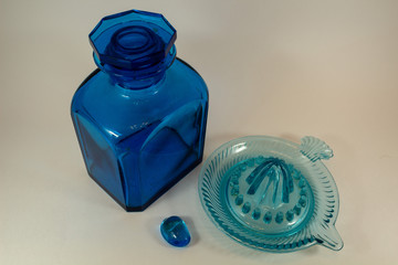 vintage blue glass bottle and vintage citrus juicer