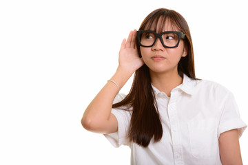 Portrait of young cute Asian teenage girl listening