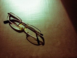 glasses on a dark background, shadow of the rim, metallic material