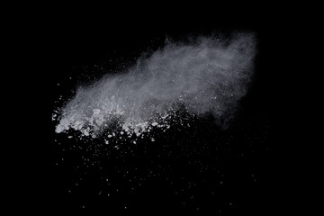 White powder explosion on black background. Dust splatted isolated. Paint Holi.