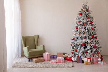 Christmas Decor Christmas tree with presents in a white room in winter