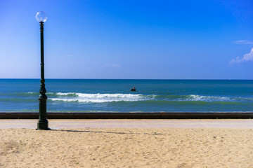 lantern at the beach with blue sky and clouds