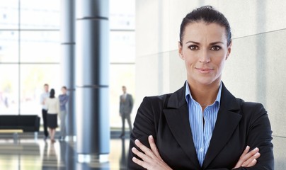 Mid-adult businesswoman indoors in office building