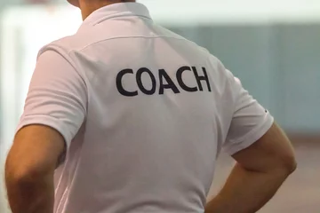 Foto op Plexiglas Back view of male sport coach with word COACH written on back of his shirt © kudosstudio