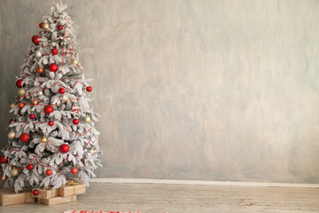 Christmas snowy Christmas tree with presents in a white room in winter