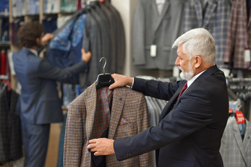 Customer thinking about buying checkerd brown jacket. 