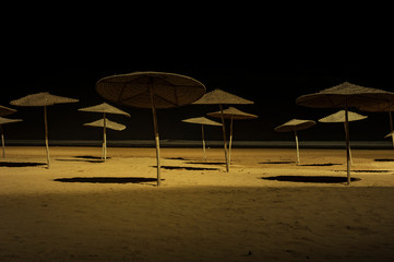 Sunshades on beach at night Essaouira, Morocco