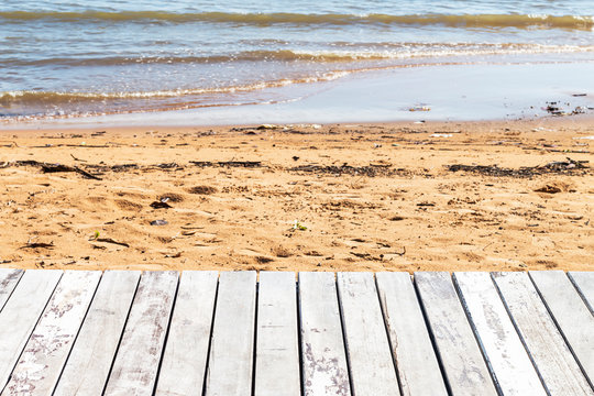 The wood floor beside the sea is not clean.