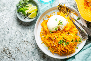 Butternut squash noodles with mozzarela, pecans, herbs, copy space