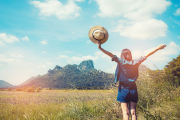Asian women Travel nature in the mountains,Young happy woman with  sit on glass  with raised hands and looking to a valley below.