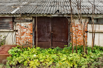 Ruined building old gate. .Abandoned collective farm. Russia, Tula region.