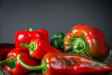 Pepper fresh red green, sweet spicy chili. Vegetables for vegetarian on wooden background. Various varieties.