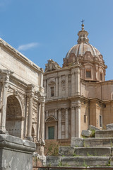 Fototapeta na wymiar Arch Septimus Severus and church St. Lucas and Martina in Forum Romanum. Rome, Italy. Vertically. 
