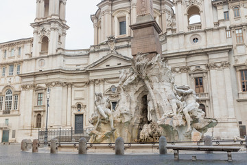 Empty Navona Square with historic Fountain of the Four Rivers and church of Sant'Agnese in Agone. Rome, Italy. 