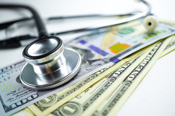 Stethoscope on US dollar banknotes, Finance, Account, Statistics, Analytic research data and Business company meeting concept