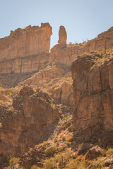 Fototapeta premium The sheer red and orange cliffs surround Canyon Lake in the wilderness desert east of Phoenix Arizona cliffs reach to the sky in this natural surrounding