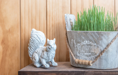 Decorated a squirrel statue and green flower pot in vintage style © Wintakorn