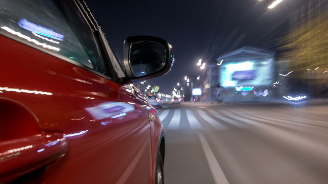 Driving Urban Look From Fast Driving Car At A Night Avenue In A City