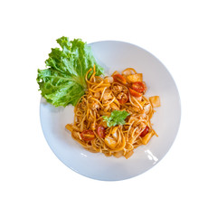 Top view plate of delicious Italian spaghetti with tomato sauce and fresh basil isolated on white background.