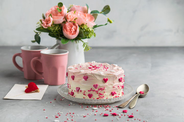 Cake with small hearts and colorful sprinkles on gray background. Romantic love background. Valentine's day card. St. Valentine's, Mother's Day, Birthday Cake Background with space for text.