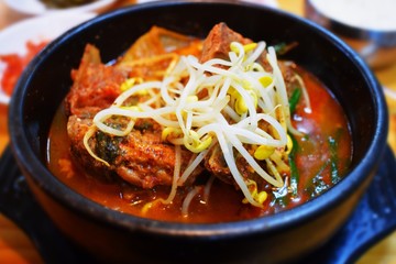 Korean soup ppyeohaejang-gug with meat, kimchi and soy sprouts
