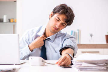 Man under stress measuring his blood pressure