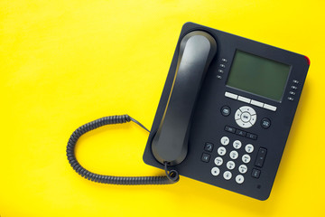 Deskphone, office and business concept. New ip phone with buttons and big display for communication without interference. Top view. Space for a text. Close up.