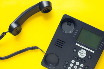 Deskphone, office and business concept. New ip phone with buttons and big display for communication without interference. Top view. Space for a text. Close up.