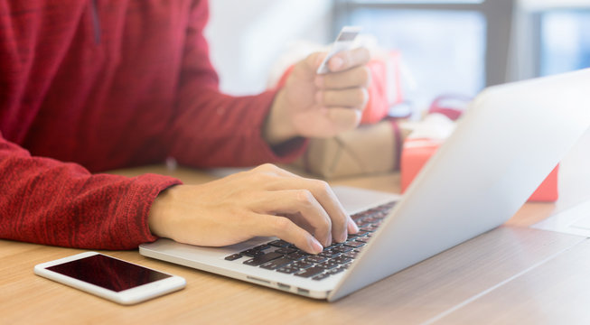 close up young man shopping online on laptop and pay by credit card on cyber monday discount promotion time , technology lifestyle and sale season festival concept