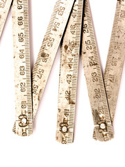 Old metal rusty folding ruler as used by carpenter.  Isolated on white