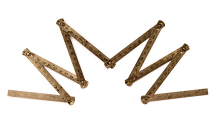 Old metal rusty folding ruler as used by carpenter.  Isolated on white