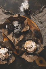 A variety of muffins on a cutting board. Top view, flat lay. Chocolate muffin.
