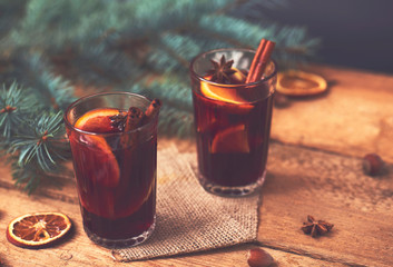 Christmas hot mulled wine with cinnamon cardamom and anise on wooden background