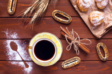 Beautiful set of bakery products and vintage cup of tea. Flat lay composition of breakfast food on the wooden background. Food, break, cooking, lifestyle concept. Top view. Close up.