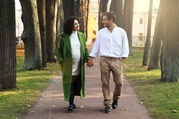 Young couple walking in the autumn Park
