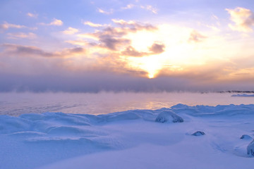 Sunset and cold fog spreads over freezing northern sea © Elina