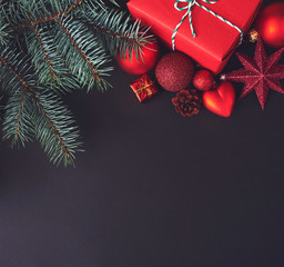 Christmas red decorations on black background. Space for text