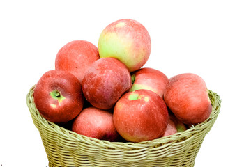 Ripe red apple in wicker basket isolated on white