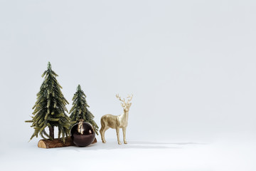 Christmas background with a christmas tree, a deer and balls.