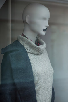 closeup of grey pullover on mannequin in fashion store showroom