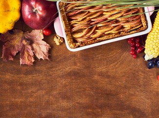 Harvest or Thanksgiving background with autumnal fruits and gourds on a rustic wooden table.   Copy space for text.