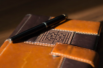 Ready-to-work business accessories: fountain pen and diary in focus