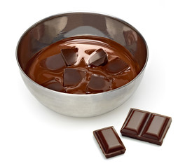 Melting chocolate with tablets in bowl isolated on white background