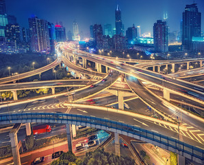 Fototapeta na wymiar Scenic view on famous highway interchange in Shanghai, China at night. Multicolored nighttime skyline.