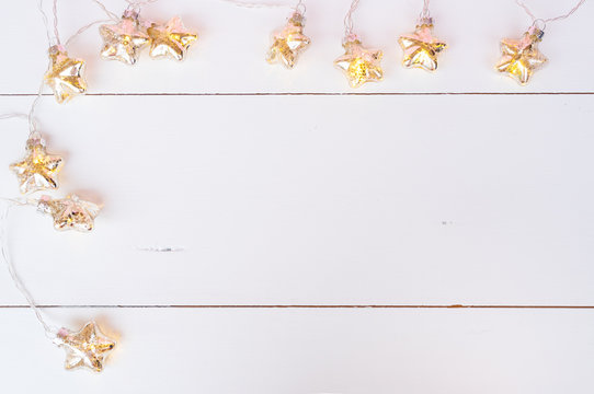 Christmas glowing garland on white wooden background