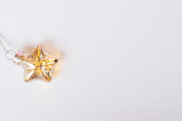 Christmas glowing star on white wooden background