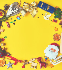 A lot of Christmas decorations and toys  on yellow background. Space for text. Design mockup