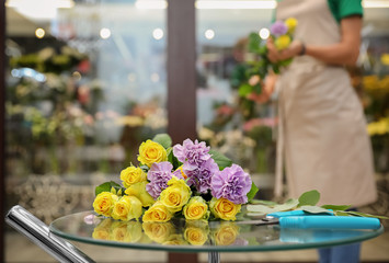 Beautiful bouquet on table in flower shop. Florist's workplace