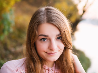 Portrait of a cute girl with a beautiful smile at sunset